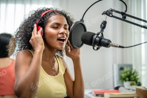 Preview: African American DJ woman sing a song on microphone to broadcasting.