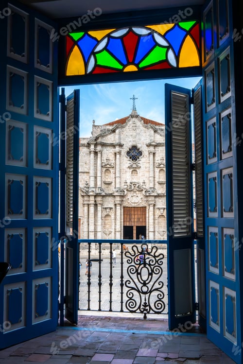 Preview: Cathedral of Havana seen through the open wooden doors of a balcony