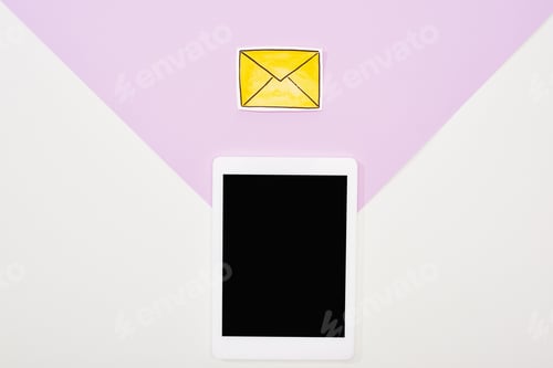 Preview: top view of digital tablet with blank screen and paper cut message icon on violet and white