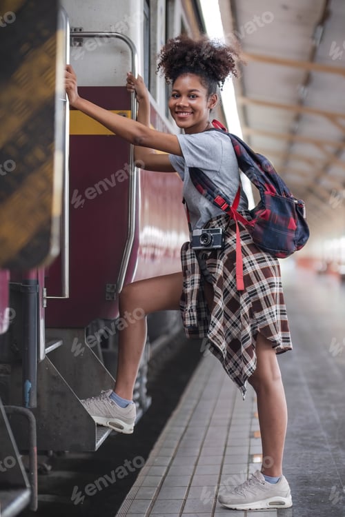 Preview: Traveler african asian american woman getting in a train to hop on train, Young woman female