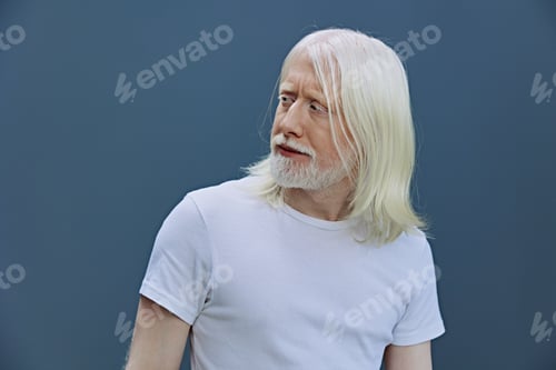 Preview: Elderly man with long white hair and beard looking to the side against a simple blue background