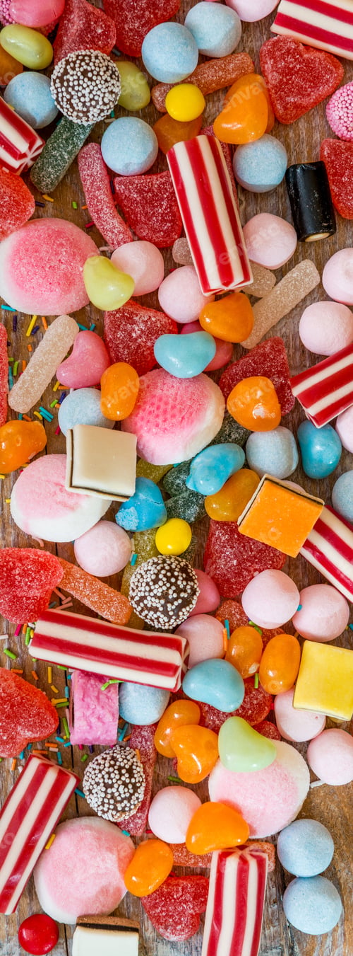 Preview: variety of candies on a wooden background
