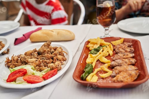 Preview: Grilled and fried chicken meat with french fries and vegetables