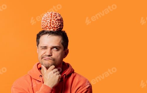 Preview: guy in a hoodie with brain on his head is thinking about something on an orange background