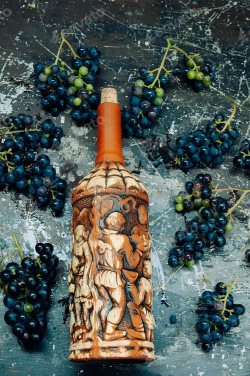 Preview: top view vintage wine bottle and dark grape on a grunge textured background