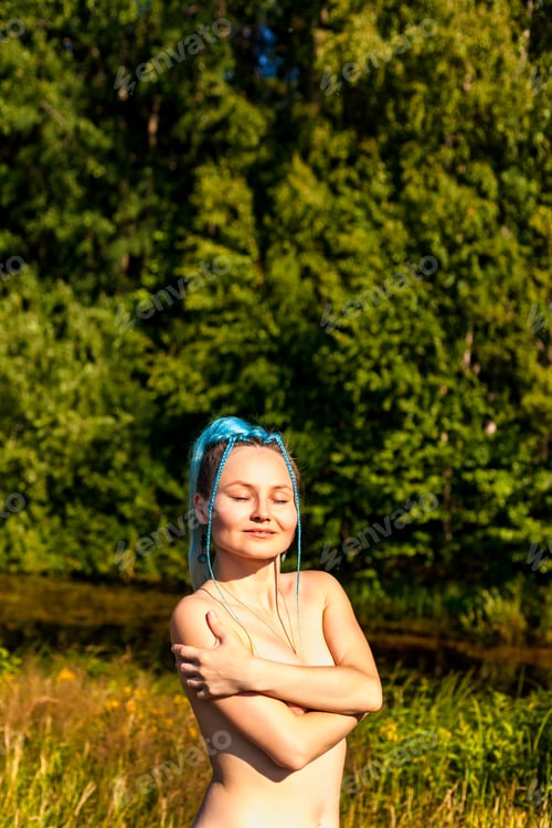 Preview: Portrait of nude woman nudist with fashionable hairstyle outdoors at nature background