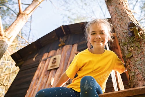 Preview: Girl plays in creative handmade treehouse in backyard, summer activity, happy childhood, cottagecore
