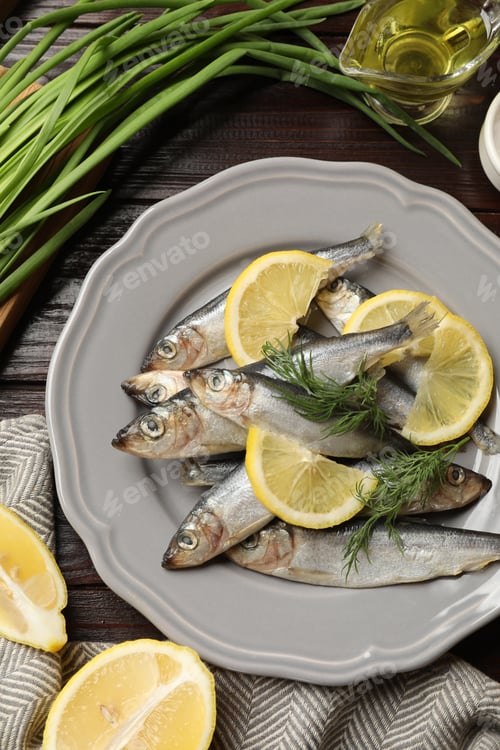 Preview: Fresh raw sprats, green onion, cut lemon and dill on wooden table, flat lay