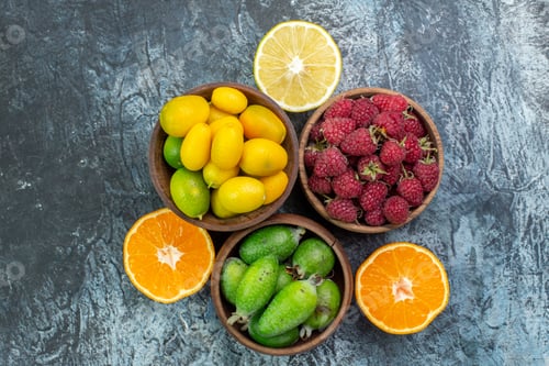 Preview: top view fresh fruits raspberries and feijoa on light-grey background color exotic mellow tropical