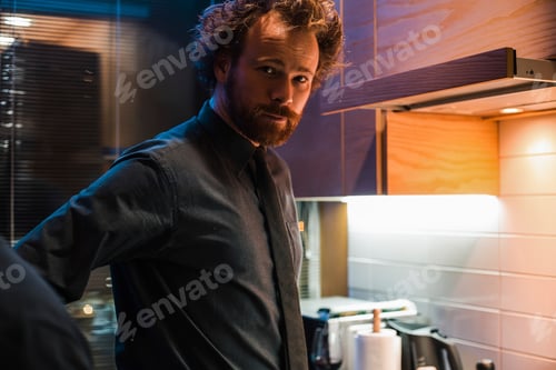 Preview: Man standing in kitchen
