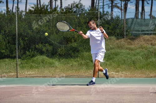 Preview: Tennis player hitting forehand at ball