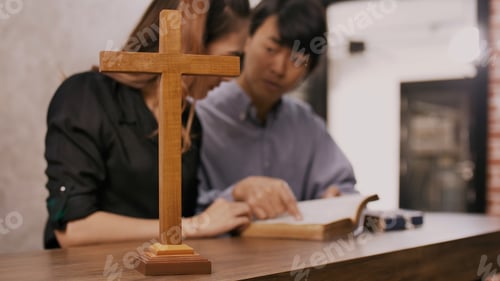 Preview: Young missionary is giving Bible advice to young woman in church.