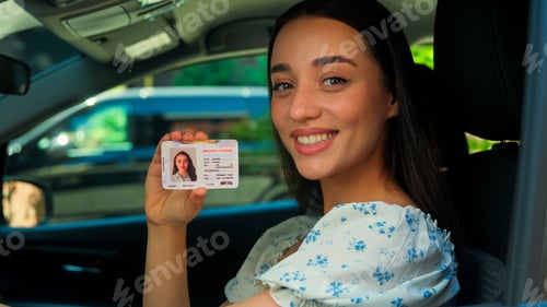 Preview: Happy smiling Caucasian joyful girl woman female driver sitting inside new car showing driving