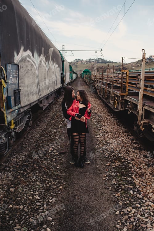 Preview: Long haired man hugging and kissing woman near train