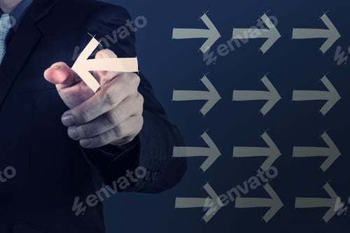 Preview: Businessman Hand Selecting Different Arrows As Leadership Concept