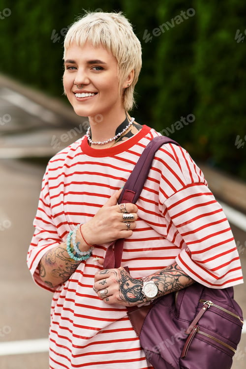 Preview: Young stylish woman enjoying a sunny day in the park with a cheerful smile and vibrant energy