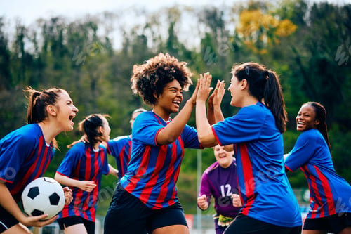 Preview: Happy women's soccer team celebrating victory after playing a match at the stadium.