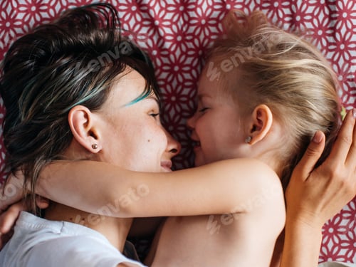 Preview: Mother and Child Embracing on Red Patterned Blanket