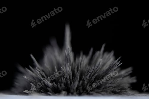 Preview: Reaction of iron dust to a magnetic field of a strong neodymium magnet on a black background