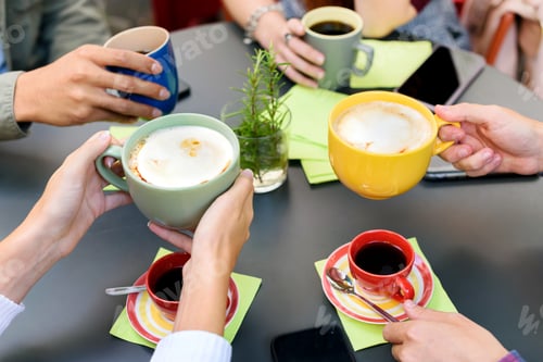 Preview: Anonymous friends drinking coffee in cafe