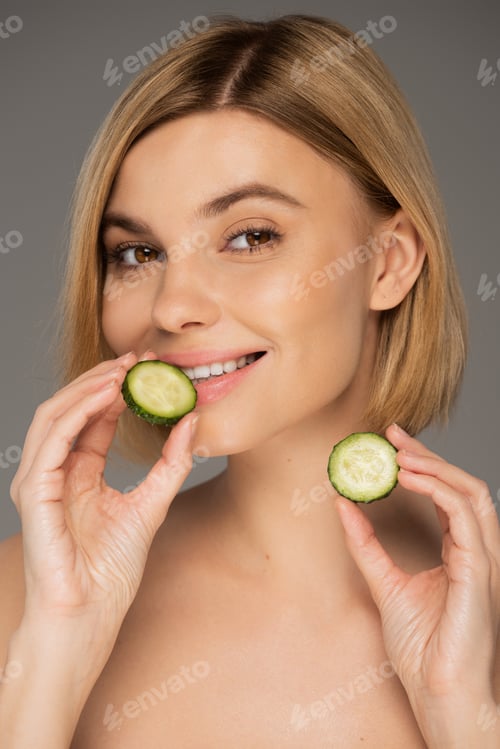 Preview: Smiling Woman with Cucumber Slices Promoting Wellness