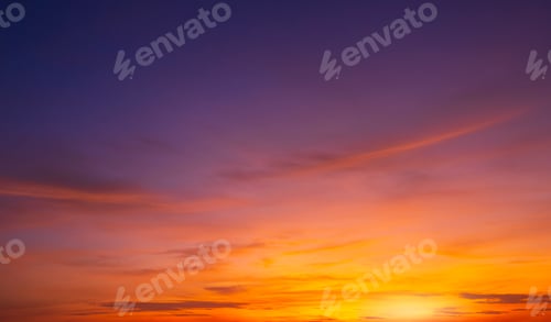 Preview: Colorful dusk sky background after sundown with orange sunlight clouds on blue twilight sky