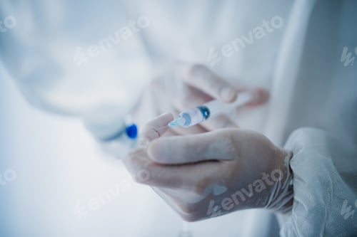 Preview: medicine health disease treatment concept, doctor injection liquid drug to saline bag in hospital