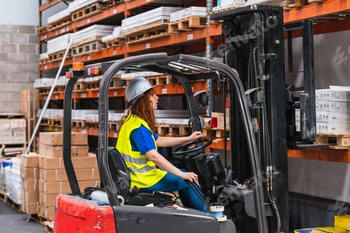 Preview: Portrait of a young worker posing during work in a warehouse