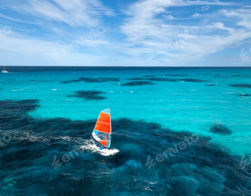 Preview: Aerial view of windsurfer on blue sea at sunny summer day