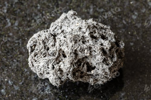Preview: sample of rough pumice rock on black granite