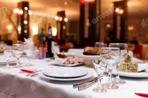 Preview: Restaurant tables set for celebration. Many food on the festive table