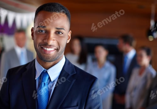 Preview: Shot of a confident businessman standing in front of his team at the office