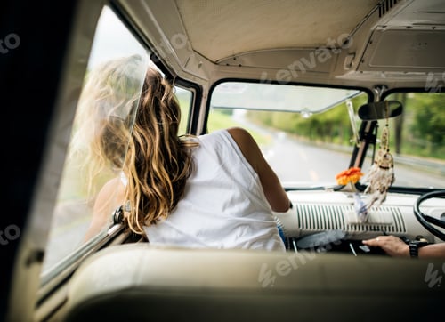 Preview: Woman Sitting in a Car Put Head Out of Window Wind Blowing Her H
