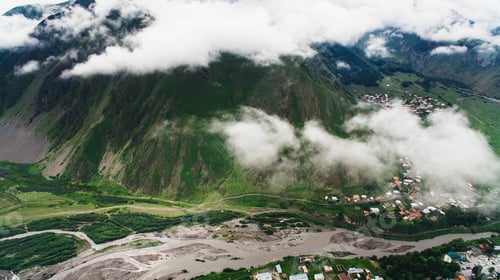 Preview: aerial view of city in green mountains with river, Georgia