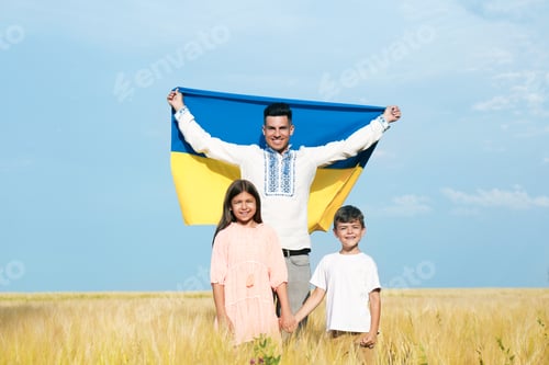 Preview: Happy family with national flag of Ukraine in field