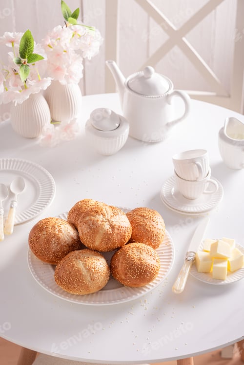 Preview: Sweet and homemade rolls with sesame seeds, butter and honey.