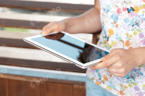 Preview: woman holding digital tablet, closeup