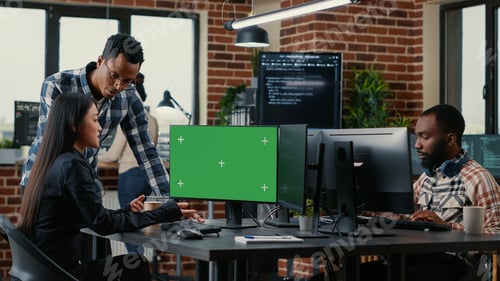 Preview: Two software developers analyzing source code looking at green screen chroma key mockup with