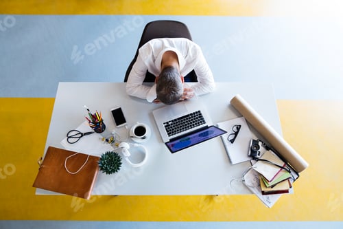 Preview: Businessman at the desk with laptop in his office.