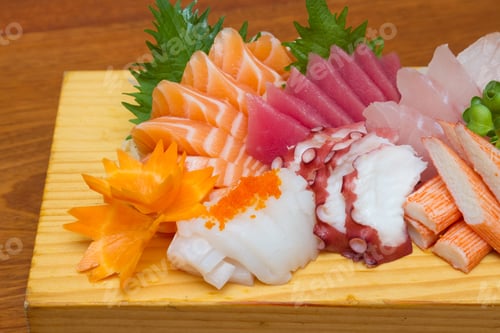 Preview: Sashimi (japanese food). Sliced raw seafood on wooden plate.