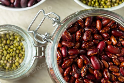 Preview: Raw cereals or beans in glass jars close up. Vegan and vegetarian food