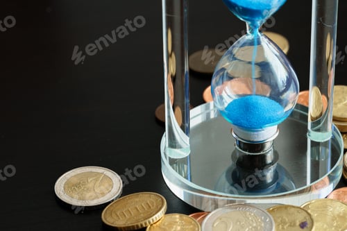 Preview: Time is money. Close up of hourglass with money coins