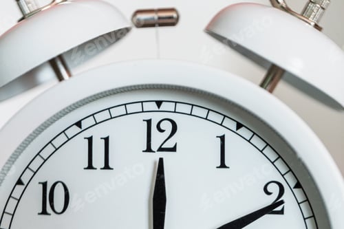 Preview: Alarm hands point to 12 o'clock. Vintage clock, macro. Lunch and deadline