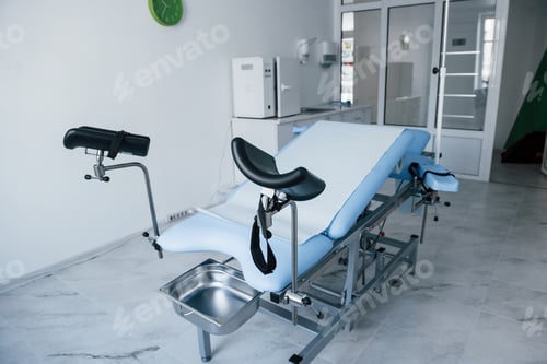 Preview: Blue colored obstetric bed indoors in the clinic cabinet at daytime