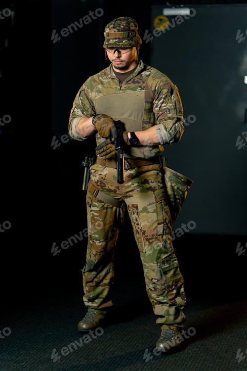 Preview: In a professional shooting range professional fighter stands fully armed during a military exercise