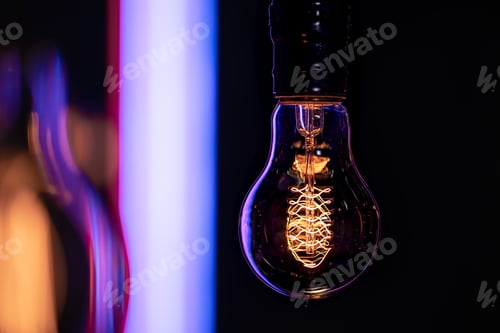 Preview: Close up of a burning lamp on a blurred dark background.