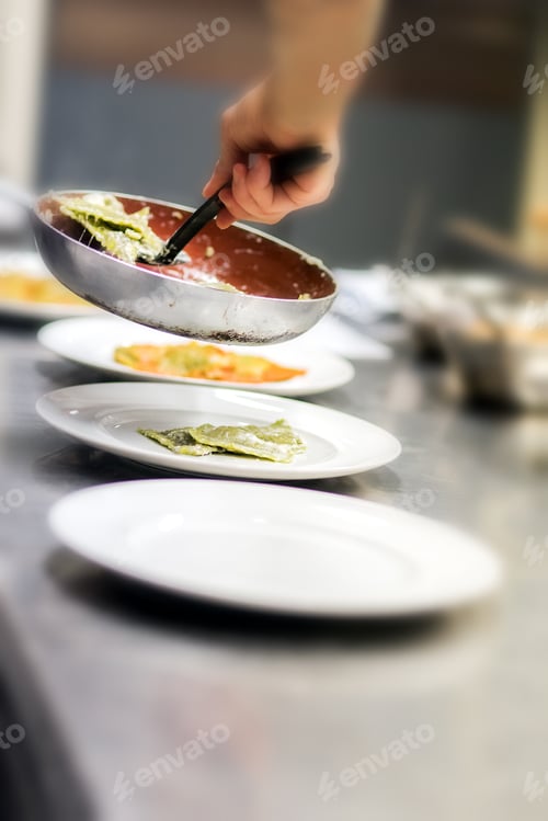 Preview: Chef serving ravioli pasta in a restaurant kitchen
