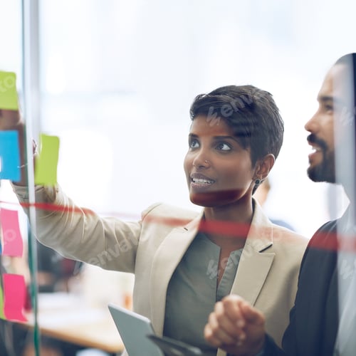 Preview: Cropped shot of two colleagues working at the idea board