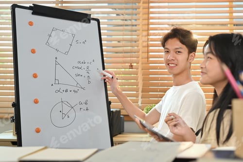 Preview: Male tutor giving private educational lesson to teenage asian girl.