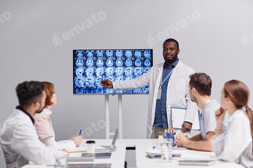 Preview: Contemporary medical expert or radiologist pointing at mri scan with x-ray images of human brain